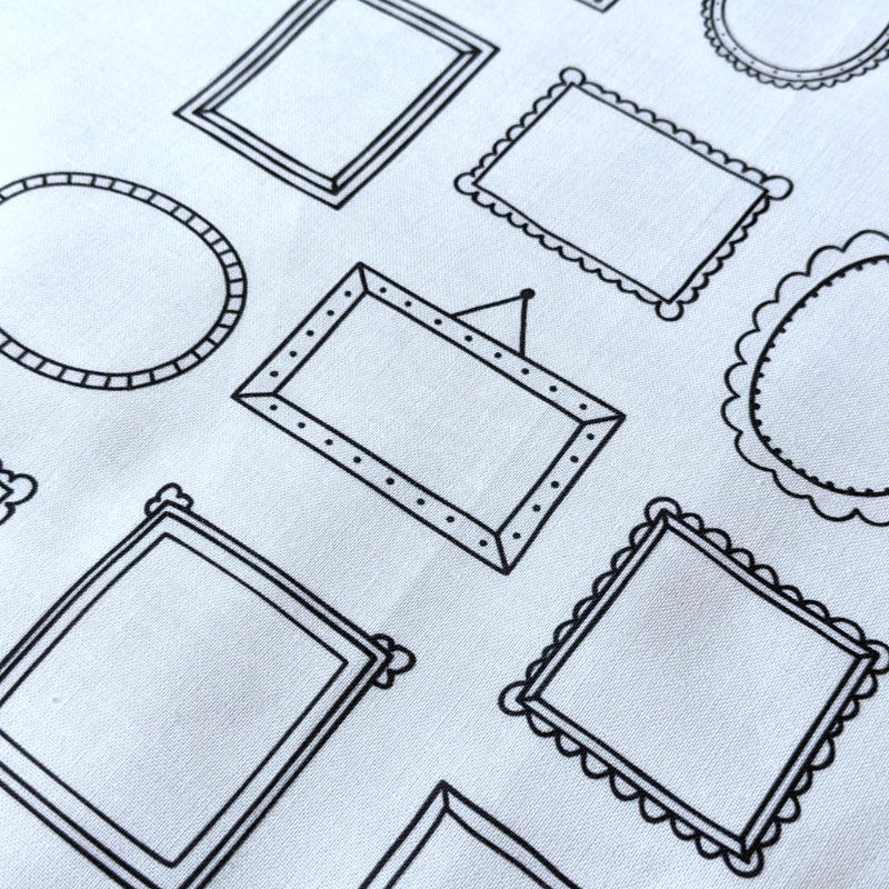 WHite fabric with the outlines of simple picture frames printed on it